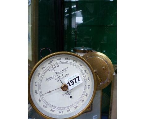 A Short & Mason aneroid barometer, a rotating desk barometer and a Negretti & Zambra barometer calculator.