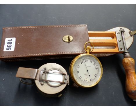 A gilt brass cased compensated pocket barometer by T. Wheeler together with a compass and a thermometer