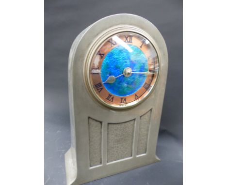 An early 20th.c.Liberty & Co tudric pewter table clock with enamelled copper dial. pat no 01269