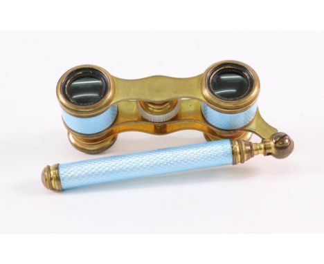 A pair of gilt metal and blue guilloche enamel opera glasses, circa 1920, with hinged tubular handle and mother of pearl adju