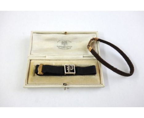 A gold, diamond, white enamel and silk bracelet, the side with a rose-diamond setting formed as a letter 'P' on a black silk 