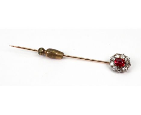 A ruby and diamond oval cluster stick pin, the central oval mixed cut ruby within a nine stone old-cut diamond surround, claw