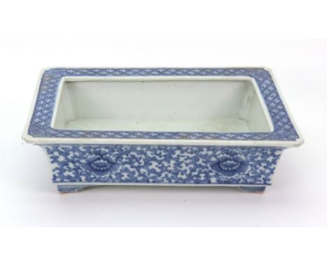 A Chinese blue and white rectangular planter, late 18th/19th century, painted with flowers and tendrils beneath a diaper patt