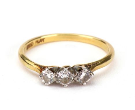 A three stone diamond ring, the brilliant cut stones approx. 0.30cts total, stamped '18ct PLAT', size R, 2.6g gross.