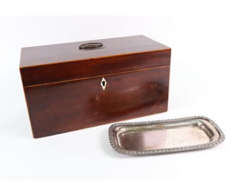A George III mahogany boxwood banded rectangular tea caddy, the hinged cover enclosing two lidded compartments flanking a mix