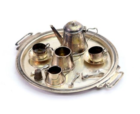 An Edwardian miniature silver tea service, Birmingham 1907, maker's mark 'S.M.L.', eleven pieces including a circular two-han