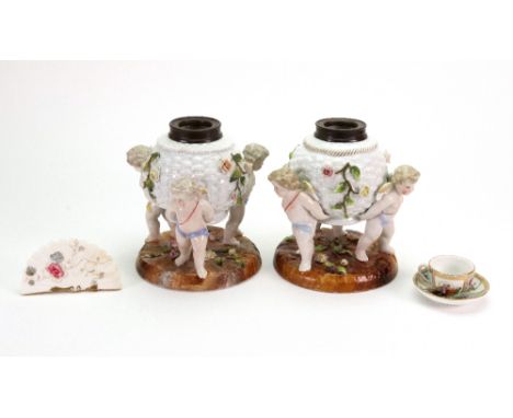 A pair of Sitzendorf oil lamp bases, of rose encrusted basket weave form, with three cherub supporters, 15cm high, miniature 