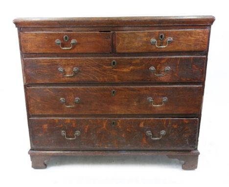 A mid 18th century oak chest, the moulded rectangular top above two short and three long drawers, on bracket feet, 111cm wide