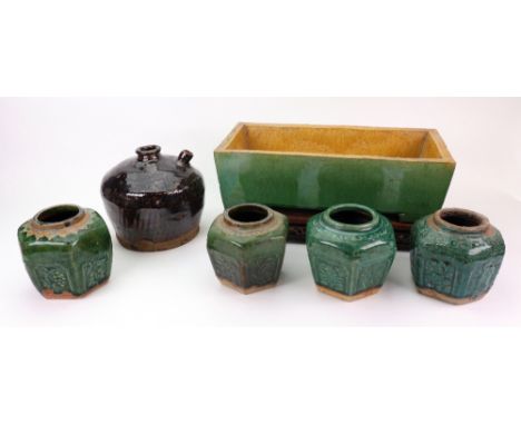 A Chinese green and ochre glazed rectangular stoneware jardiniere, raised on four bracket feet, impressed marks, 30cm length,
