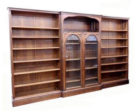 An early 20th century oak breakfront library bookcase, in 18th century style, of panelled construction, the gadroon and denti