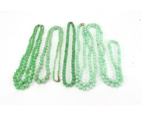 A mottled light green glass bead long necklace of uniform beads, a two-row pale mottled green jade necklace, and two single r