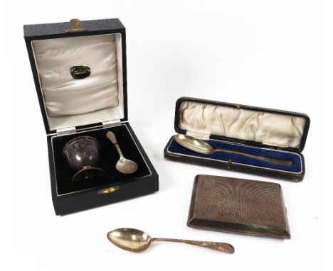 An Art Deco engine turned silver cigarette case, Birmingham 1930, a cased silver egg cup and spoon, a cased silver spoon, ins