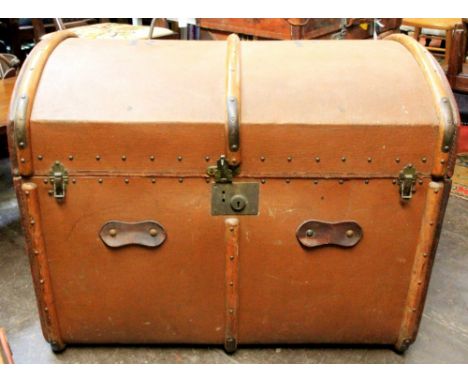 A large late Victorian wooden battened canvas trunk, the hinged domed top enclosing a lift-out tray, 85cm wide.