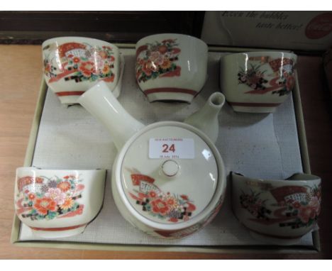 A boxed Japanese style tea service including pot and bowls 