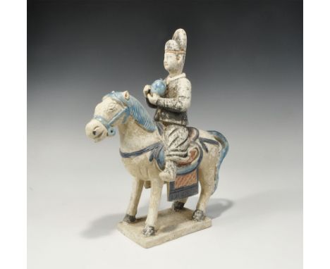 An undated archaistic glazed ceramic horse and rider figurine in Ming Dynasty, 1368-1644 AD style comprising: a standing hors
