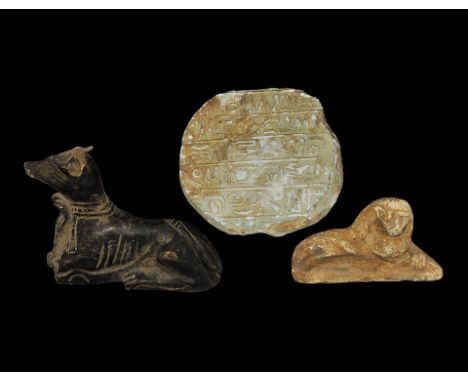 20th century AD. A mixed group comprising: a ceramic plaque of a recumbent lion, modelled in the half-round; a composition fi