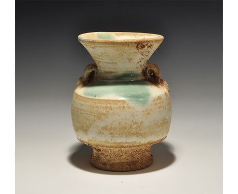 An undated archaistic cream-glazed barrel-shaped ceramic jar with flared base and neck, two lateral loops to the shoulder, gr