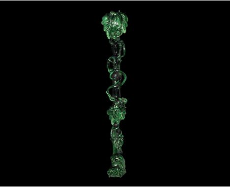 An undated archaistic green-glazed ceramic ruyi sceptre with undulating faux-bamboo shaft, applied tendrils and foliage detai
