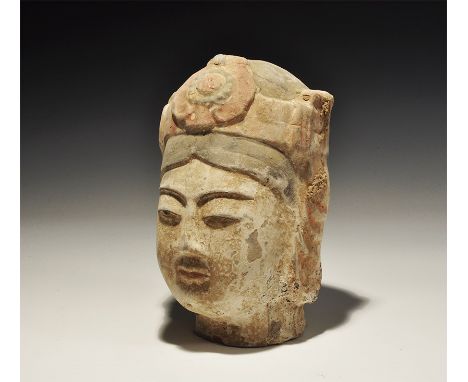 19th-20th century AD. A hollow-formed ceramic female Bodhisattva head with painted detail in red, black and coral-pink. 616 g