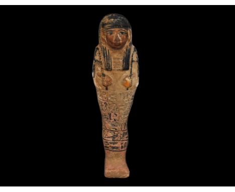 20th century AD. A glazed composition shabti with black detailing to the wig, facial features, tools and hieroglyphs. 258 gra
