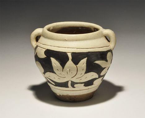 20th century AD. A cream-glazed ceramic jar with narrow base and broad mouth, two ribbed loop handles to the sides; band of b