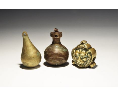20th century AD. A mixed group of brass items comprising: a piriform clock weight with pierced upper end; a bulbous weight wi