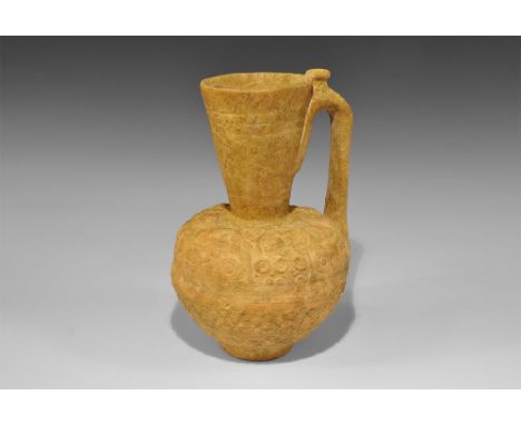 An undated archaistic vessel in 12th-14th century AD style comprising a bulbous jug with funicular neck and strap handle to t