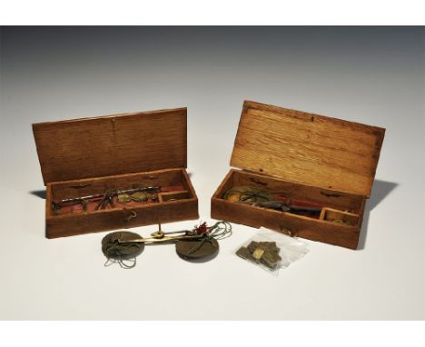 Late 19th-early 20th century AD. A mixed group comprising: a wooden cased set with white metal scale balance and two glass pa