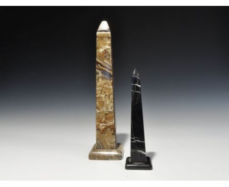 20th century AD. A pair of polished stone obelisks comprising: one in black on low base; one hollow with hole to the base sui