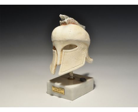 20th century AD. A ceramic Corinthian style helmet on a base with pointillé inscription '???????' (Marathon), plaque to the b