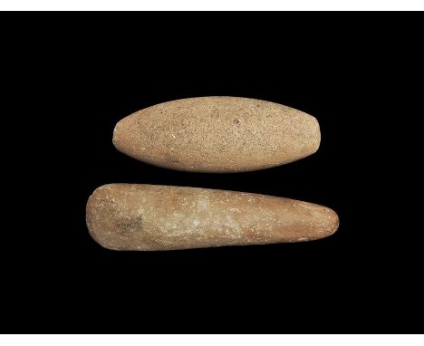 5th-2nd millennium BC. A group of two rhyolite hand tools comprising a round-section axe with narrow butt and keeled edge, an