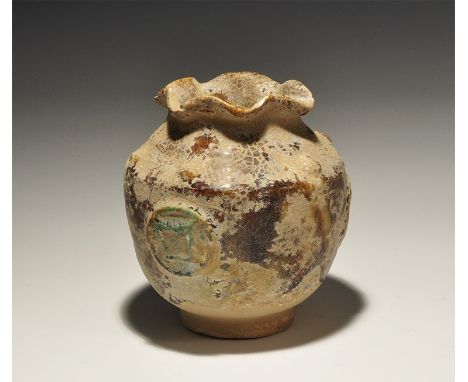 An undated archaistic squat ceramic jar with narrow base and everted petal rim; the surface crackle-glazed with three green-g