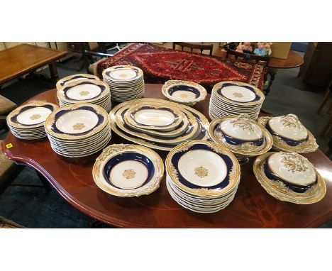 A large 19th century porcelain dinner service including meat platters, tureens, serving bowls and sauce tureens, setting for 