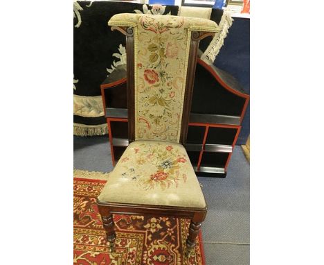 A 19th century rosewood prayer chair having a tapestry seat and back over turned legs