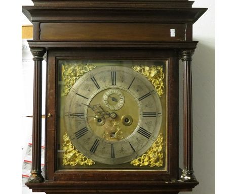 A George III oak long case clock having a gilt and silvered dial, column supports over a panel trunk, eight day movement