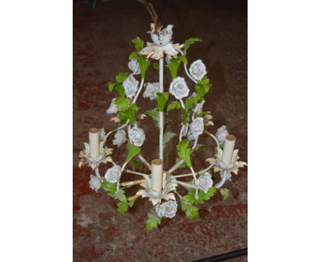 A painted metal and polychrome decorated ceramic mounted chandelier with floral decoration