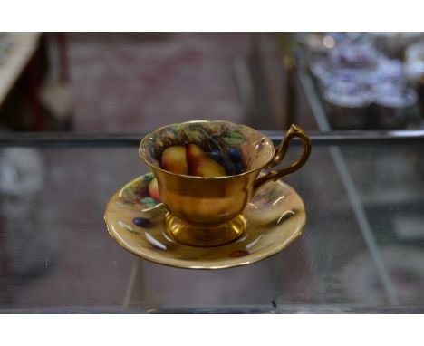 A Royal Worcester coffee cup and saucer, painted with Autumnal fruit and signed by W.Hale, date code for 1926