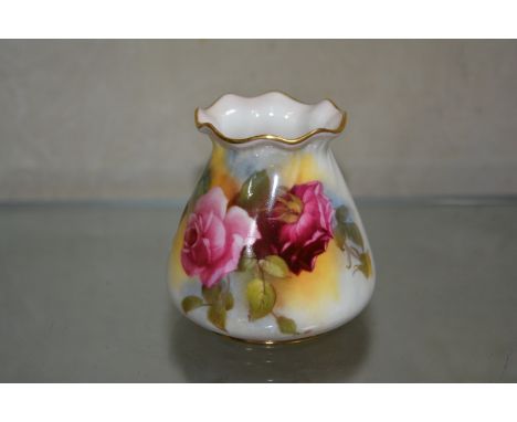 A pair of Royal Worcester purse vases, painted with roses, green printed marks, date code for 1915, shape G 957, 8cm high