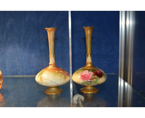 A pair of Royal Worcester vases painted with roses, of compressed globular form with tall slender necks, shape no. 1748, date