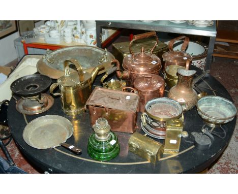 A collection of copper and brassware to include copper kettles, a copper lidded vessel, a pierced brass planter, pots, scales