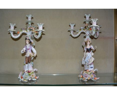 A pair of German porcelain (Plaue) flower encrusted figural four-light candelabra, 40cm high