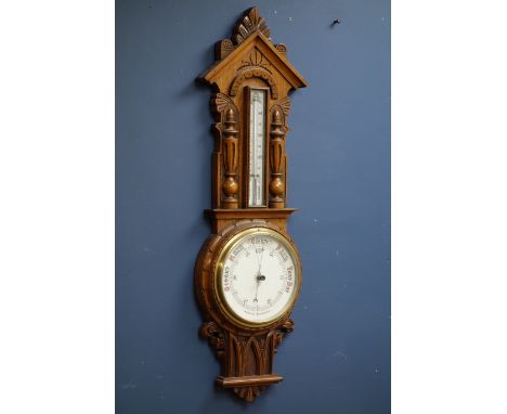 Early 20th century aneroid barometer and thermometer in carved oak case, H90cm   Condition Report   Click here for further im