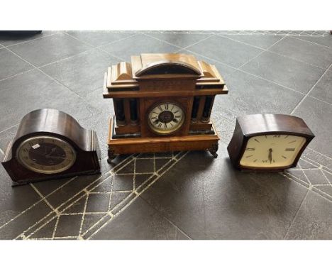 Three Wooden Mantle Clocks, comprising a column decorated clock with brass scroll feet, white face and Roman numerals.  Measu