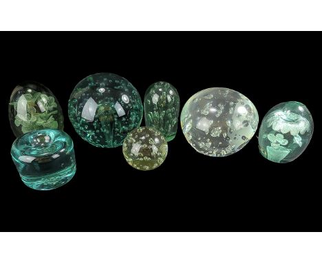 Seven Vintage Large Paperweights, two large globe shaped bubble decorated one green and one clear, two domed with floral inse