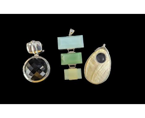 Three Silver Heavy Pendants, comprising a silver circular pendant set with a black faceted stone, a silver pendant formed of 