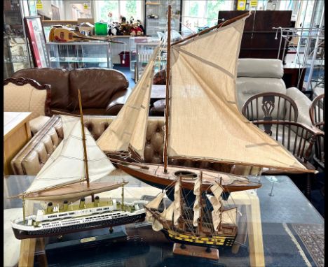 A Collection of Model Boats, ( 4 ) In Total. To Include a Model of the Titanic, 2 Yachts + A Pirate Ship. 