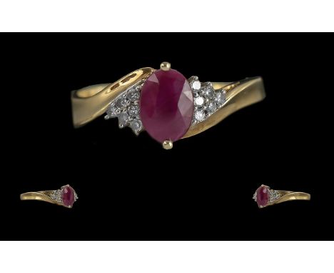 Ladies - Attractive Ruby and Diamond Set Ring. Full Hallmark to Interior of Shank. The Oval Shaped Faceted Ruby of Excellent 