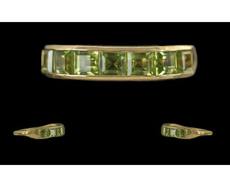 Step Cut Peridot Half Eternity Ring, a row of channel set, square, step cut peridots, totalling over 3cts, set in 18ct gold v