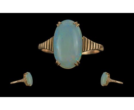 Ladies - Attractive 9ct Gold Single Stone Opal Set Ring, Marked to Shank. Ribbed Setting. The Large Opal of Good Colours - Bl
