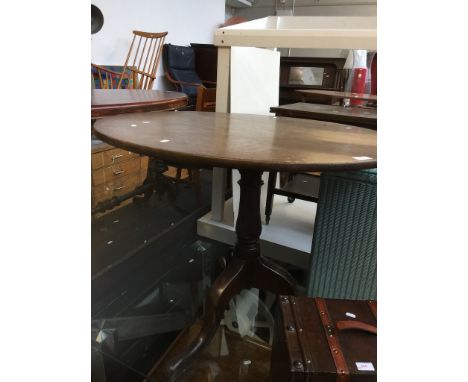 A GEORGIAN OAK TRIPOD TABLECONDITION: SURFACE SCRATCHES WITH POSSIBLE WATER MARKS TO TOP SURFACE, STRESS CRACKS TO PILLAR AND